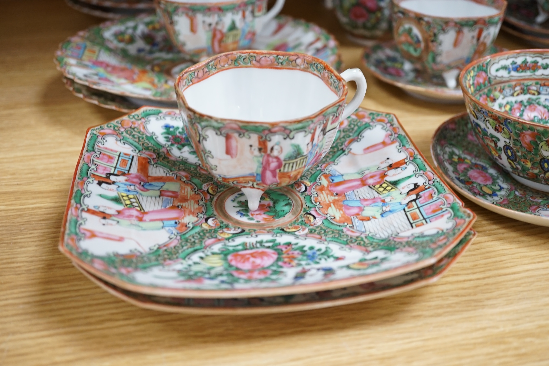 A Chinese famille rose part tea set including: five cups saucers and side plates, a teapot and cover, sugar bowl and cover, a cream jug, four cake plates and two square plates (27)